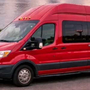 Red passenger van parked near waterfront