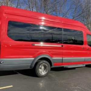 Red high-roof passenger van parked outdoors